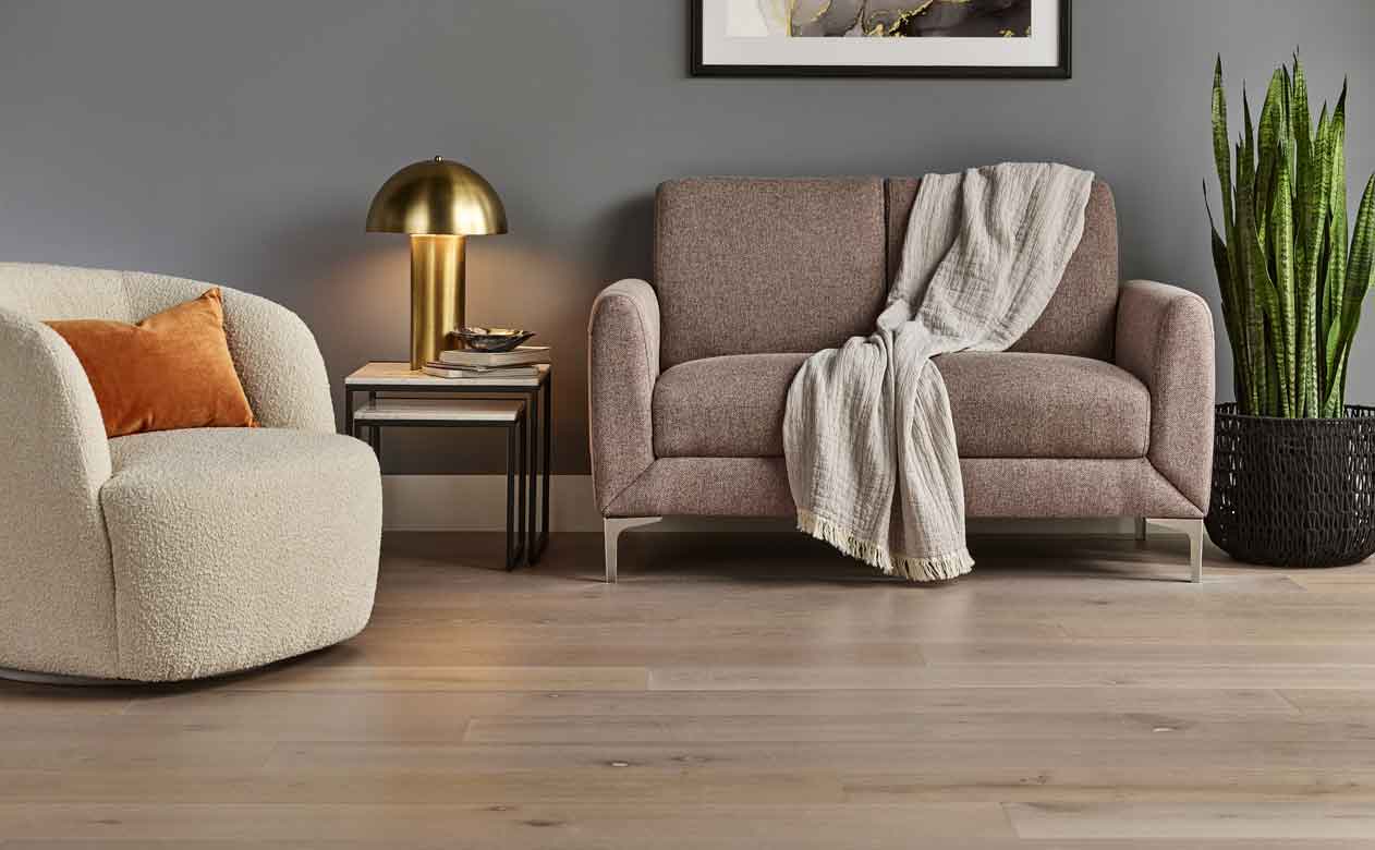 hardwood flooring in a living room with cream accent chair