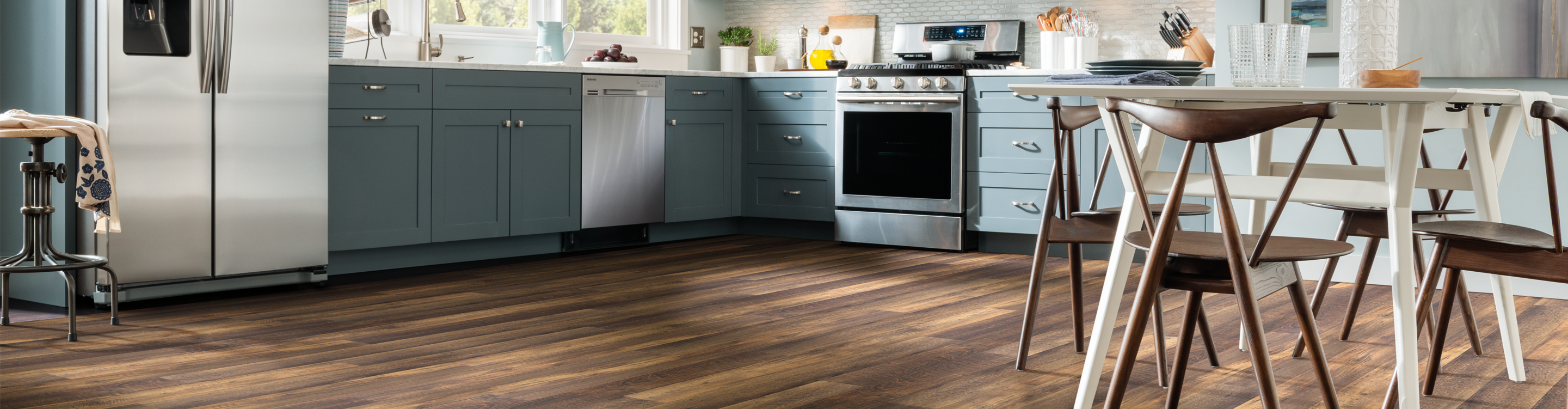 Rustic wood look vinyl plank floor in casual, modern kitchen. 